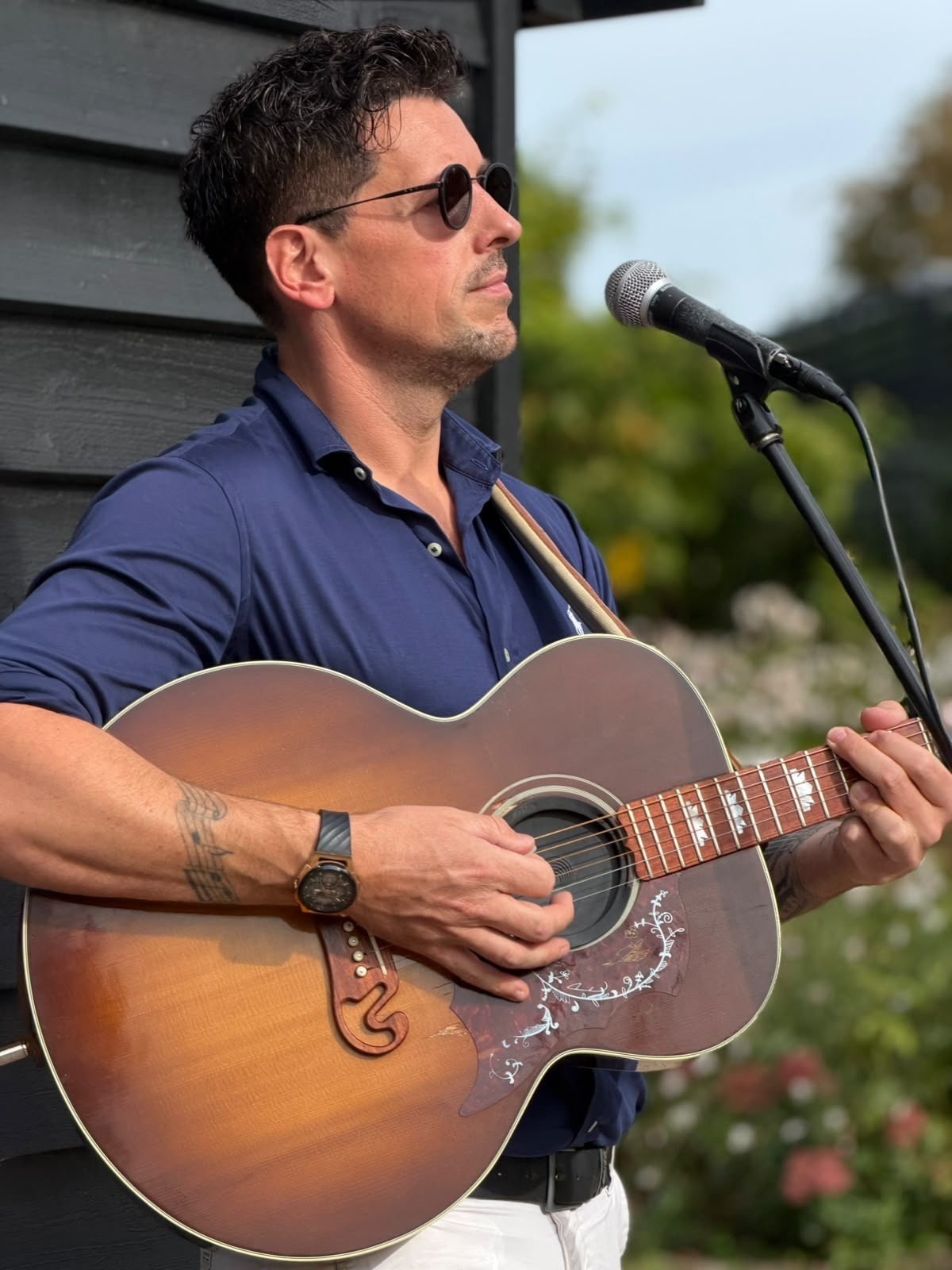 Matt performing acoustic guitar and vocals outdoors