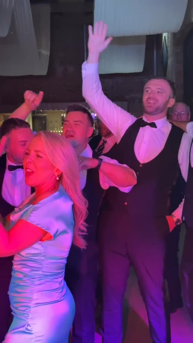 Guests singing along at a wedding party